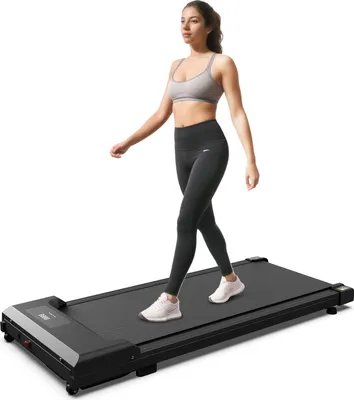 A woman is walking on a treadmill.