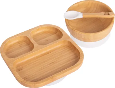 A bamboo segmented plate and bowl with a spoon, set against a white background.