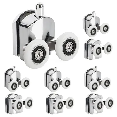 A collection of shower door rollers arranged on a white background.