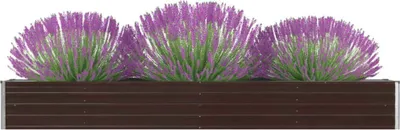 A brown metal raised garden bed filled with purple and green plants.