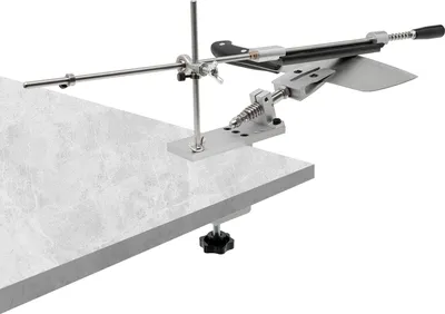 A knife sharpening system clamped to the edge of a countertop.