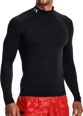 A man wearing a black long-sleeved shirt and red shorts.