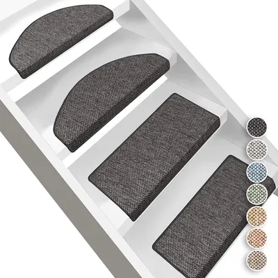 Several anthracite-colored stair mats are shown on white stairs.