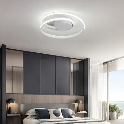 A modern bedroom with a stylish ceiling light.