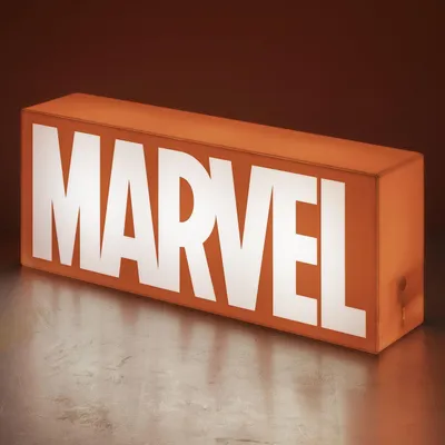 A rectangular light box with the MARVEL logo illuminated in white on an orange background, placed on a textured surface.