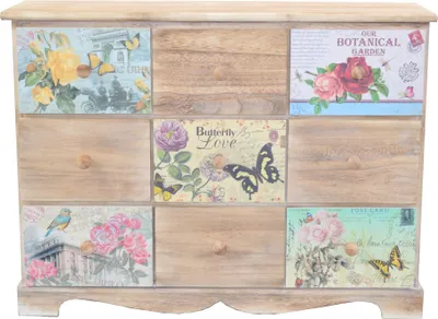 A wooden chest of drawers with decorative panels on each drawer.