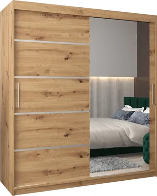 A bedroom scene reflected in a mirrored wardrobe door.