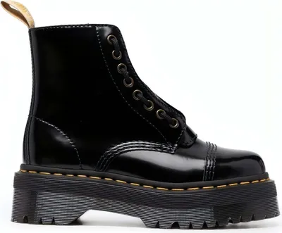 A black Dr. Martens boot with a platform sole is shown against a white background.