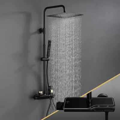 A black shower system with a square overhead showerhead and a handheld showerhead, mounted on a gray wall. Water is actively flowing from the overhead showerhead.