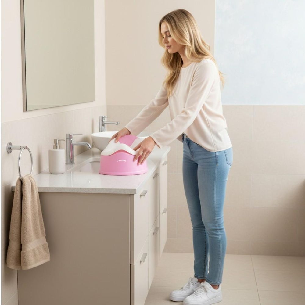 Adulte déplaçant le pot bébé SUN BABY sur un meuble de salle de bain