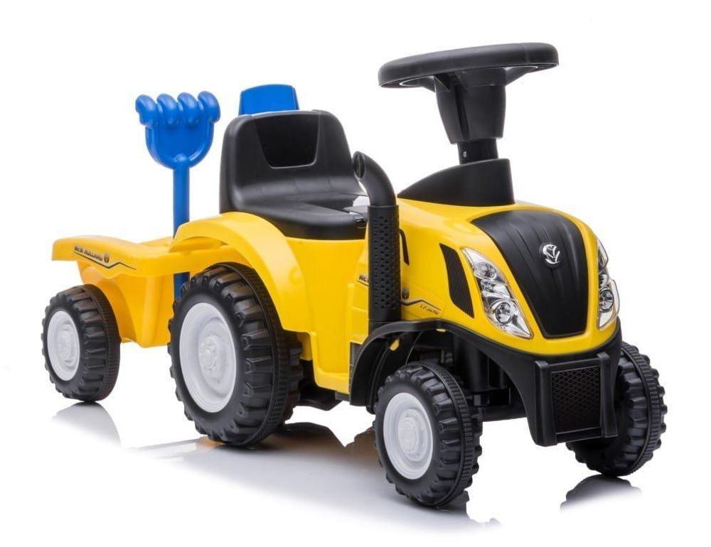 Porteur tracteur SUN BABY avec accessoires pelle et râteau fixés à la remorque.
