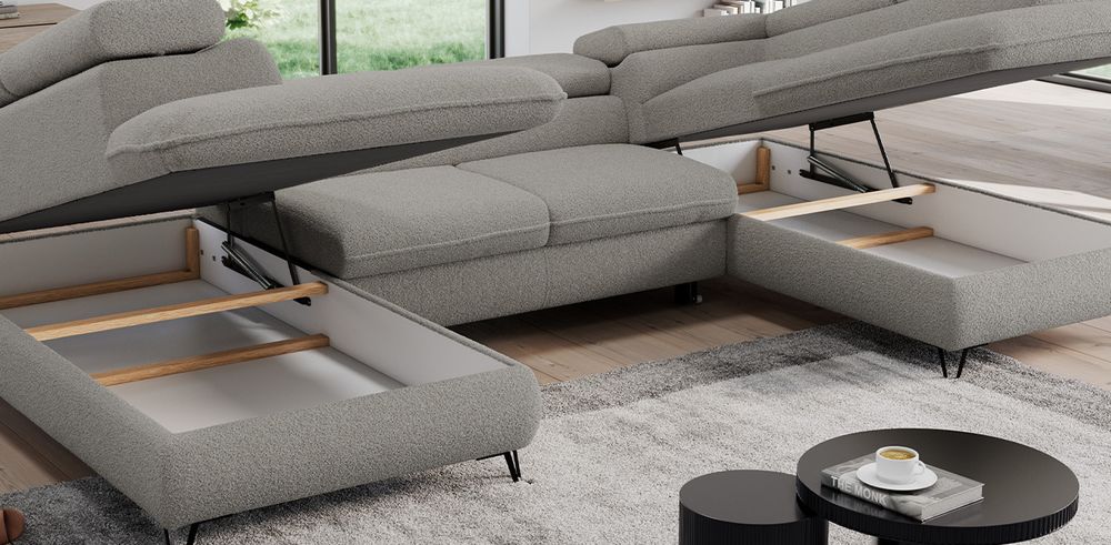 Graufarbenes Ecksofa aus boucle Stoff. Foto zeigt Bettkasten