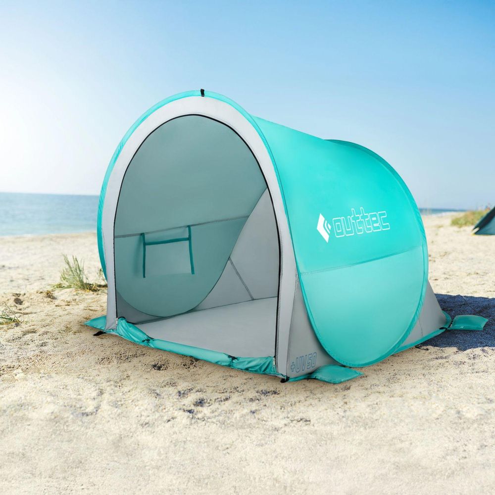Türkisfarbenes Pop-Up Strandzelt am Meer bietet schnellen UV50 Schutz