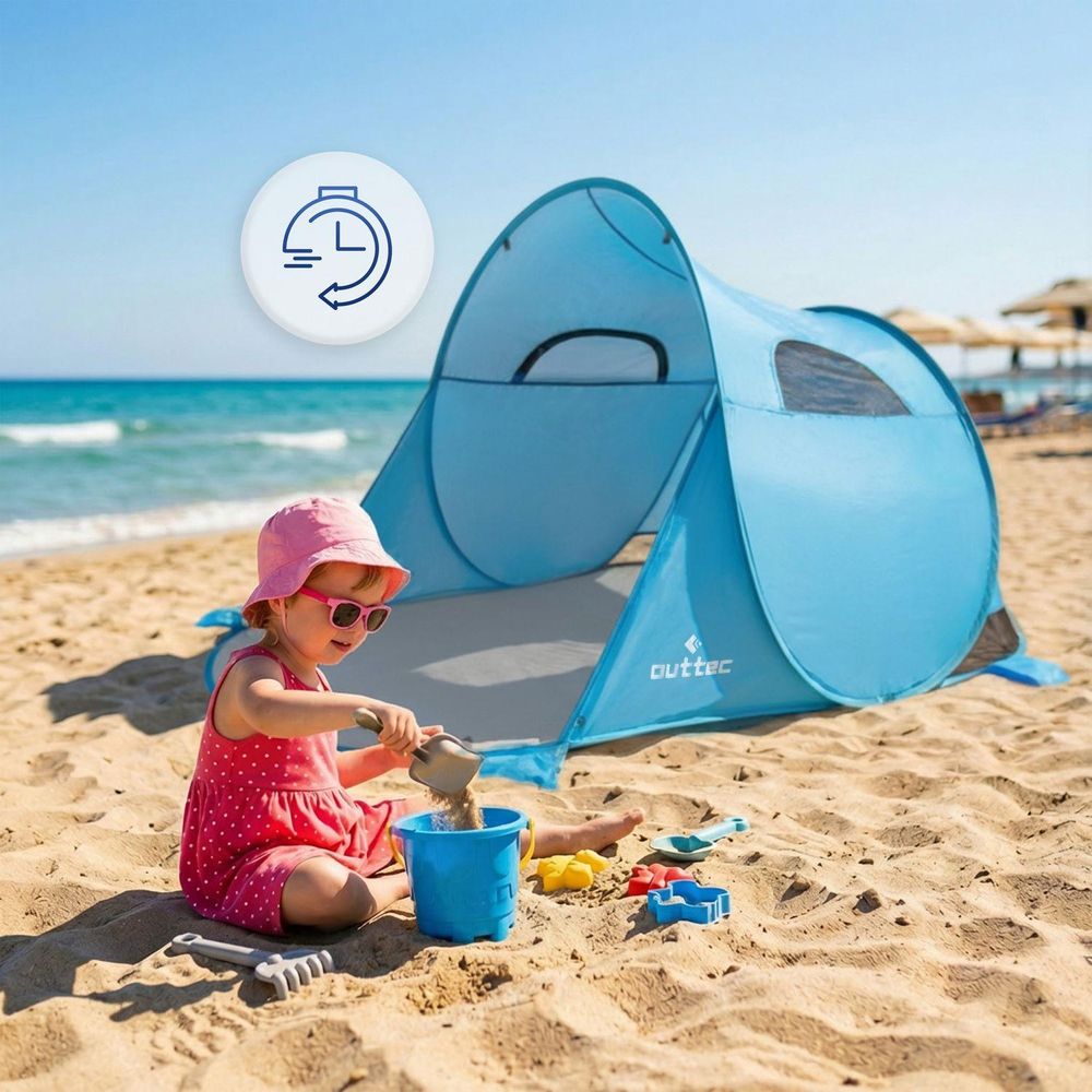 Kinder spielen im Sand, blaues Pop-up-Strandzelt im Hintergrund