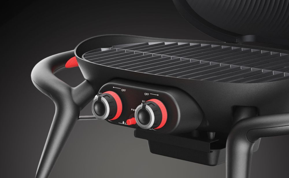 Das Bild zeigt einen schwarzen Tischgrill mit 2 Drehreglern, Griffen und einem Thermometer.