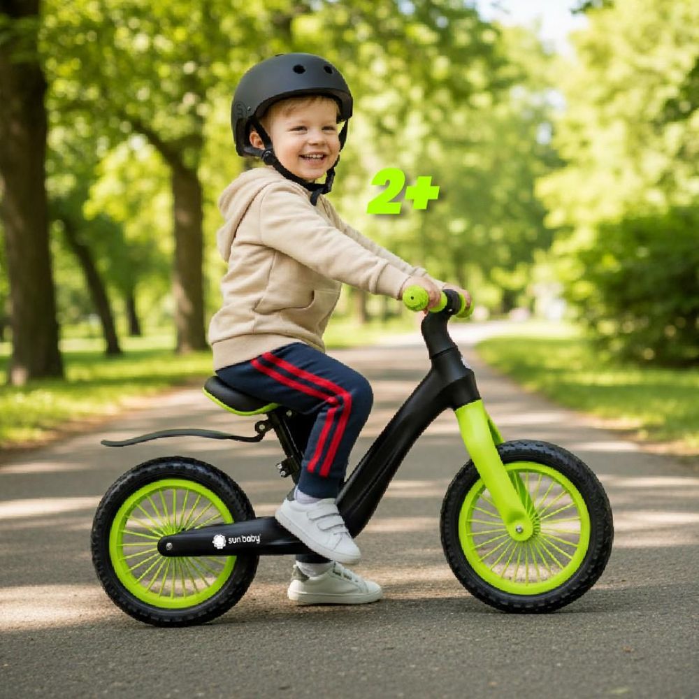 Niño de 2 años montando la bicicleta Sun Baby Sport en un entorno natural.