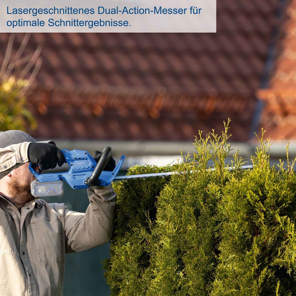 Das Bild zeigt eine Person beim Arbeiten mit der Heckenschere.