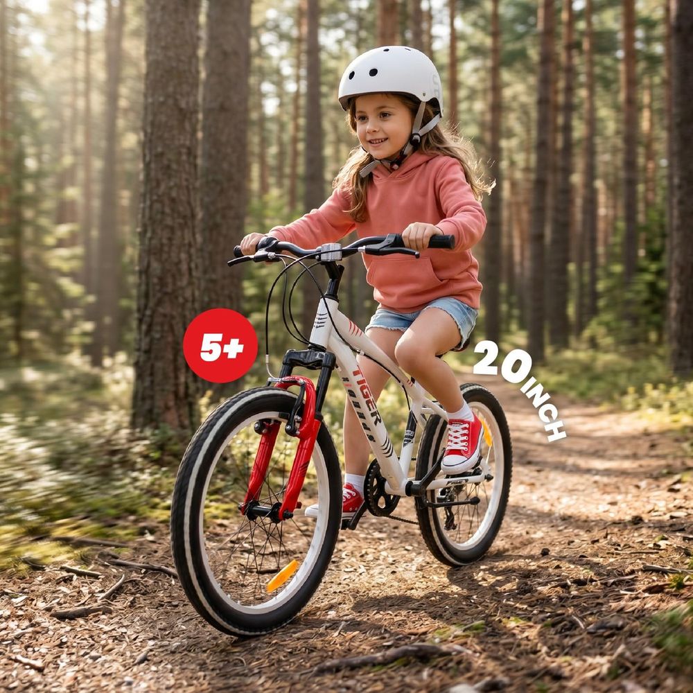 Niña montando la bicicleta SUN BABY Tiger Bike de 20 pulgadas en un bosque.