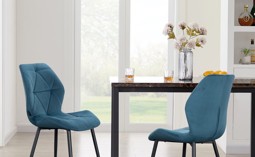Das Bild zeigt einen Tisch mit zwei Stühlen und einer Vase.