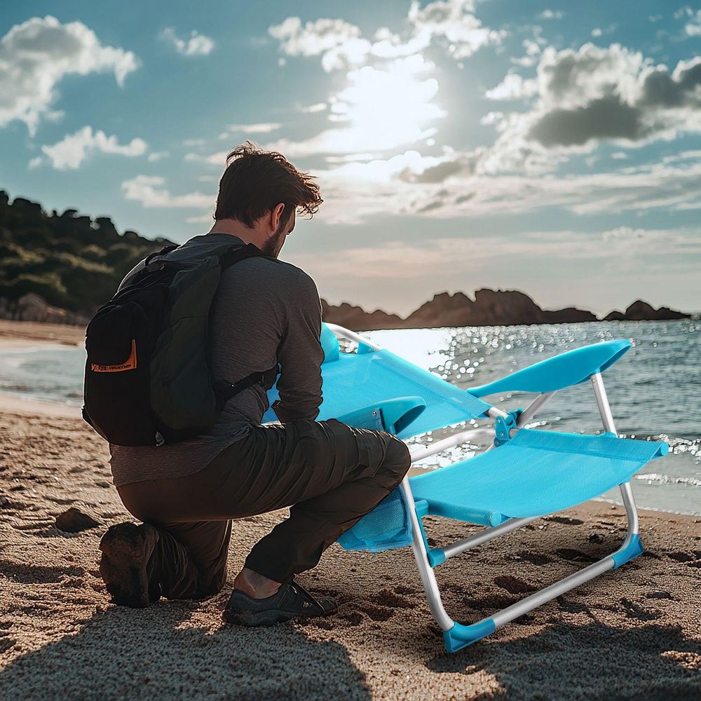 Klappbarer Strandliegestuhl am Meer. Mann entspannt sich auf dem Liegestuhl
