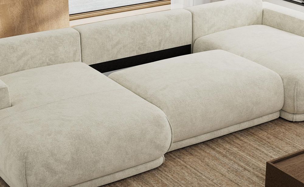 Detailansicht eines beigen Sofas mit Bettkasten und gepolsterter Sitzfläche.