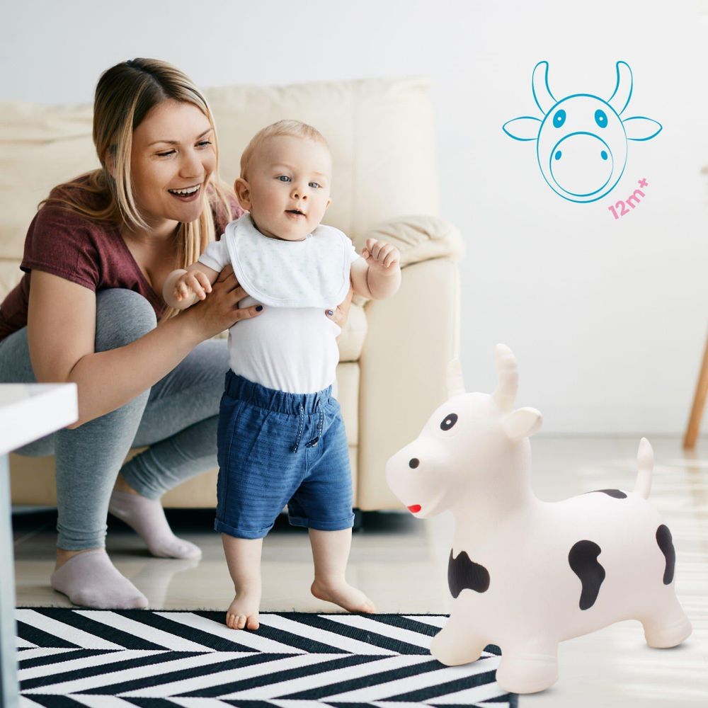 Bambino e mamma giocano con il saltarello toro bianco in salotto