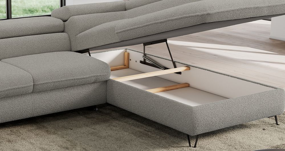Graufarbenes Ecksofa aus boucle Stoff. Foto zeigt Bettkasten