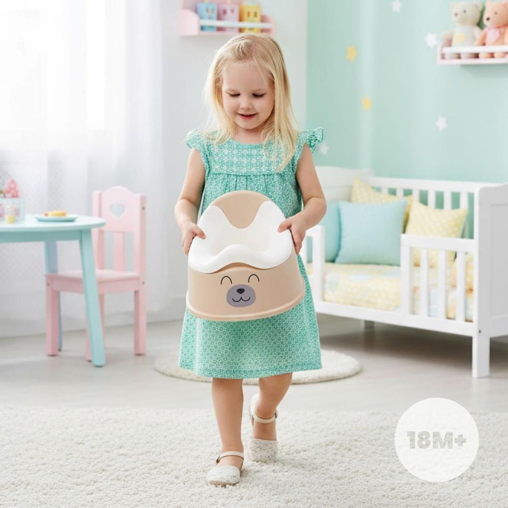 Petite fille portant le pot bébé SUN BABY dans une chambre d'enfant.