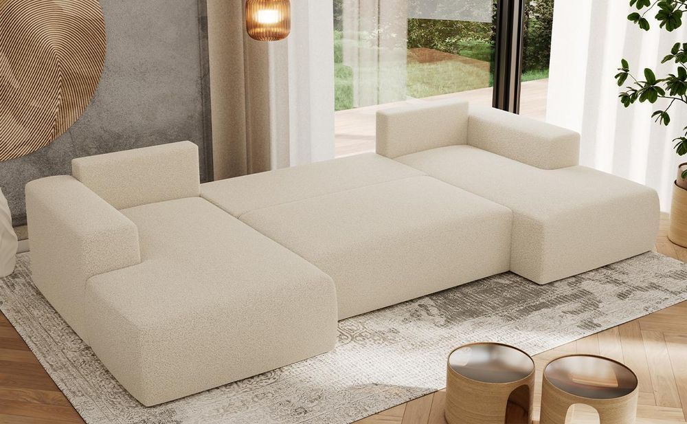 Graues Sofa mit ausgezogener Schlaffunktion im modernen Wohnzimmer.