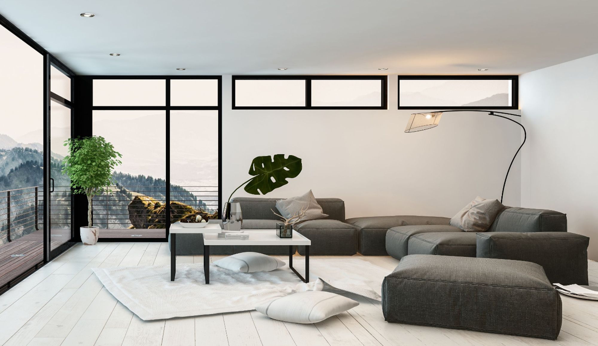 Das Bild zeigt ein Wohnzimmer im industriellen Stil mit großer, dunkelgrauer Couch.