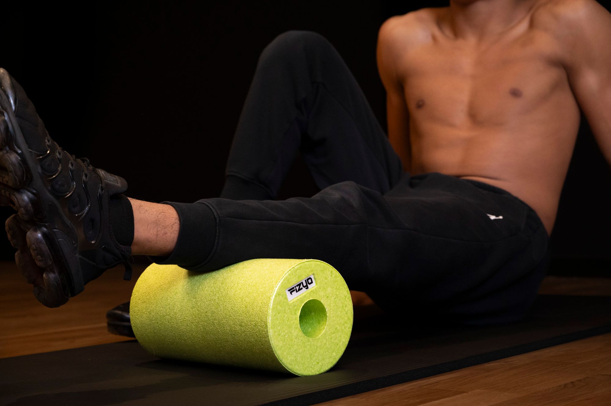 Training mit der FIZYO Massagerolle – Person führt Entspannungs- und Kräftigungsübungen durch.