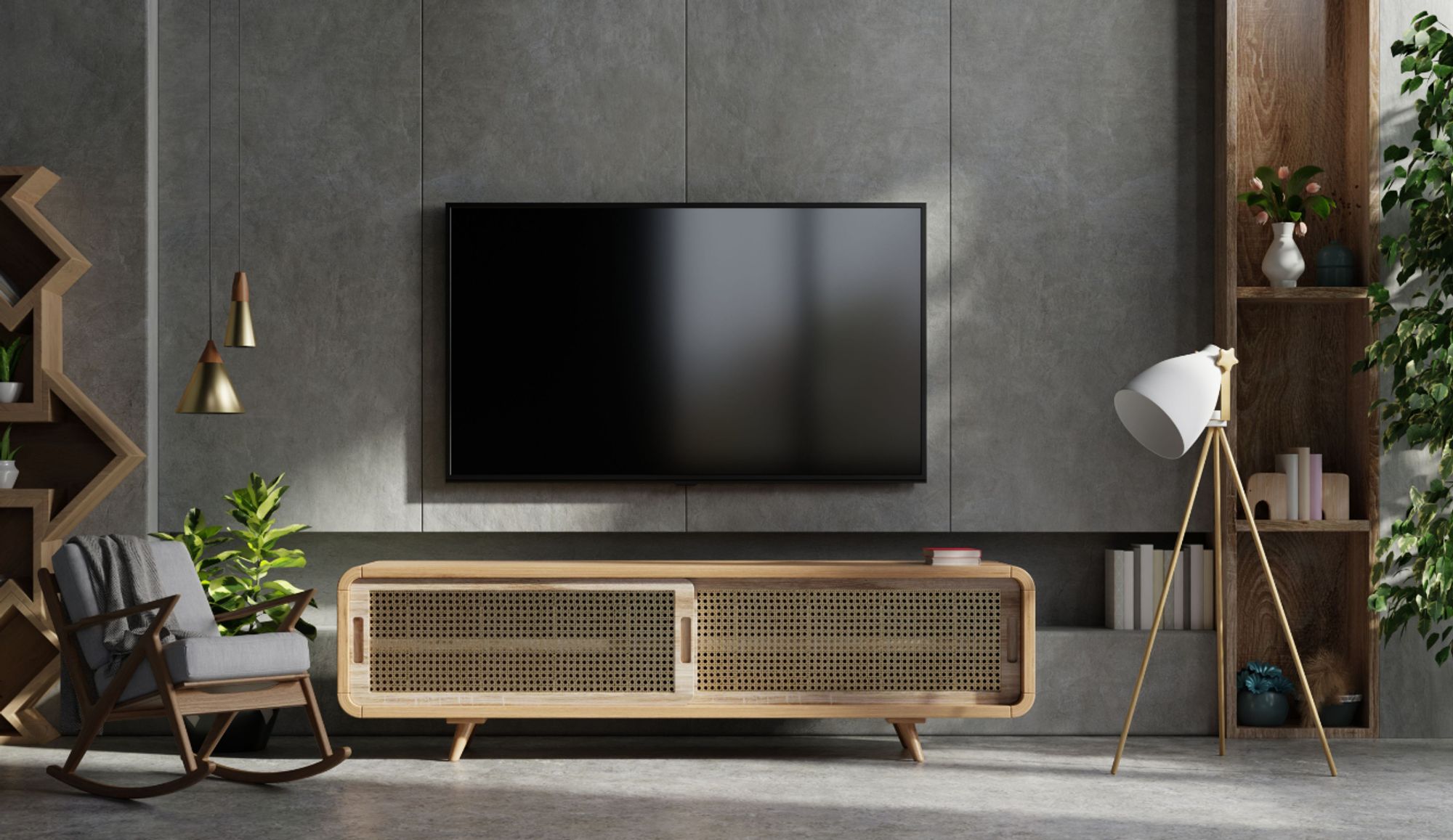 Das Bild zeigt eine Wohnzimmerwand mit großem TV, Schaukelstuhl, Lowboard und Stehlampe.