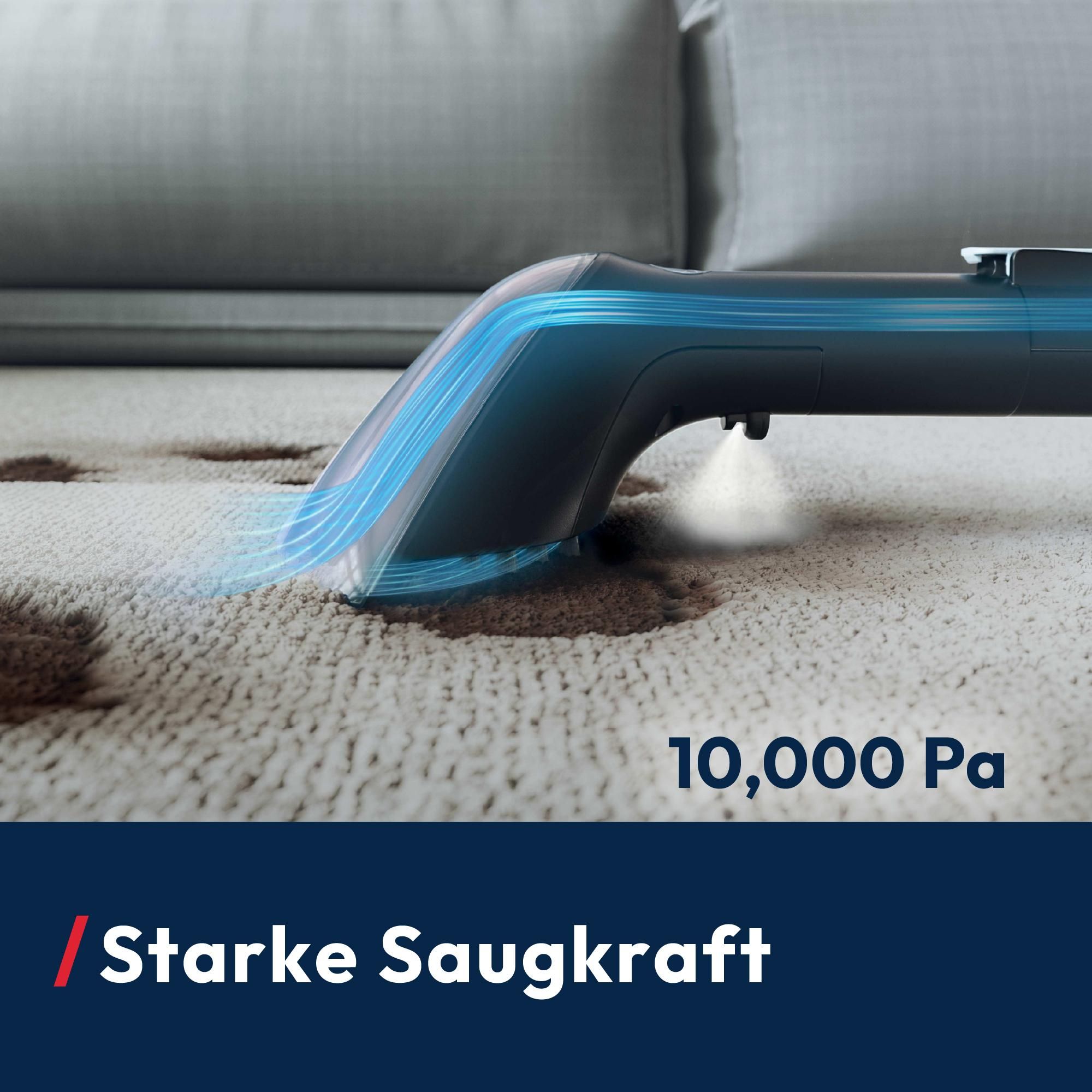 Staubsauger mit Sprühkopf bei Anwendung auf dem Teppich
