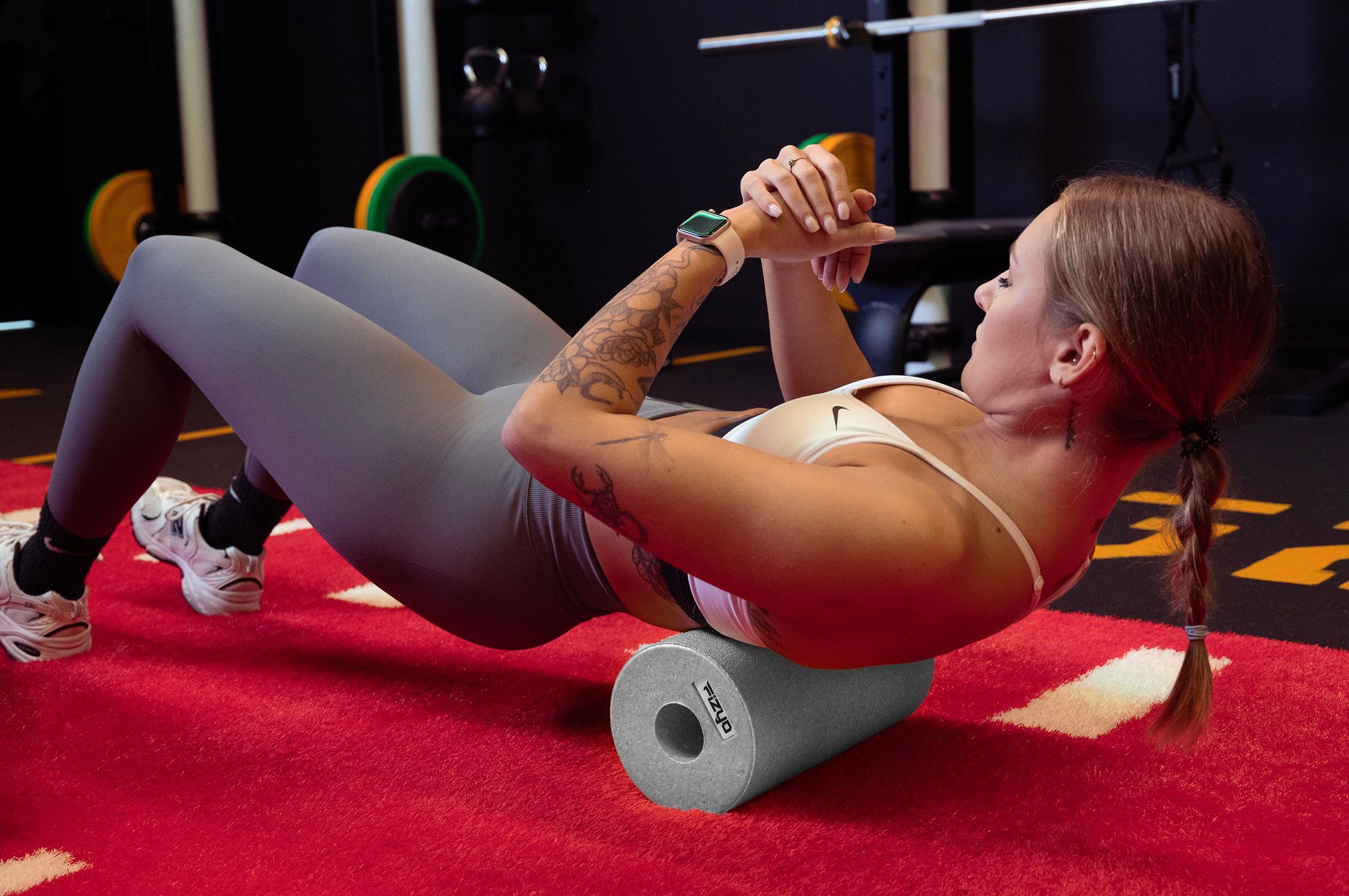 Training mit der FIZYO Massagerolle – Person führt Entspannungs- und Kräftigungsübungen durch.